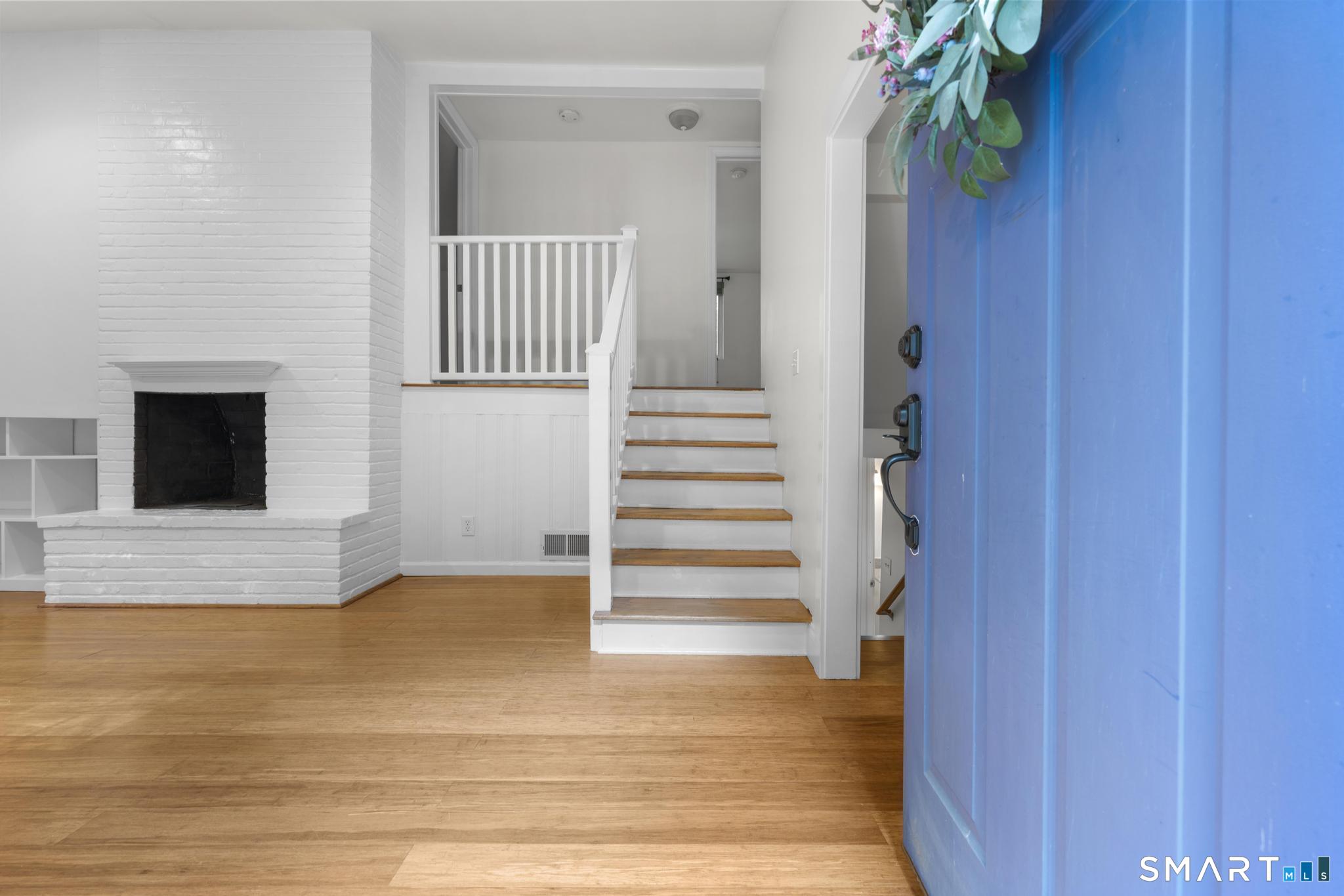 89 Book Hill Road Essex, CT 06426 - Photo 11 of 40 a view of a hallway with wooden floor and staircase