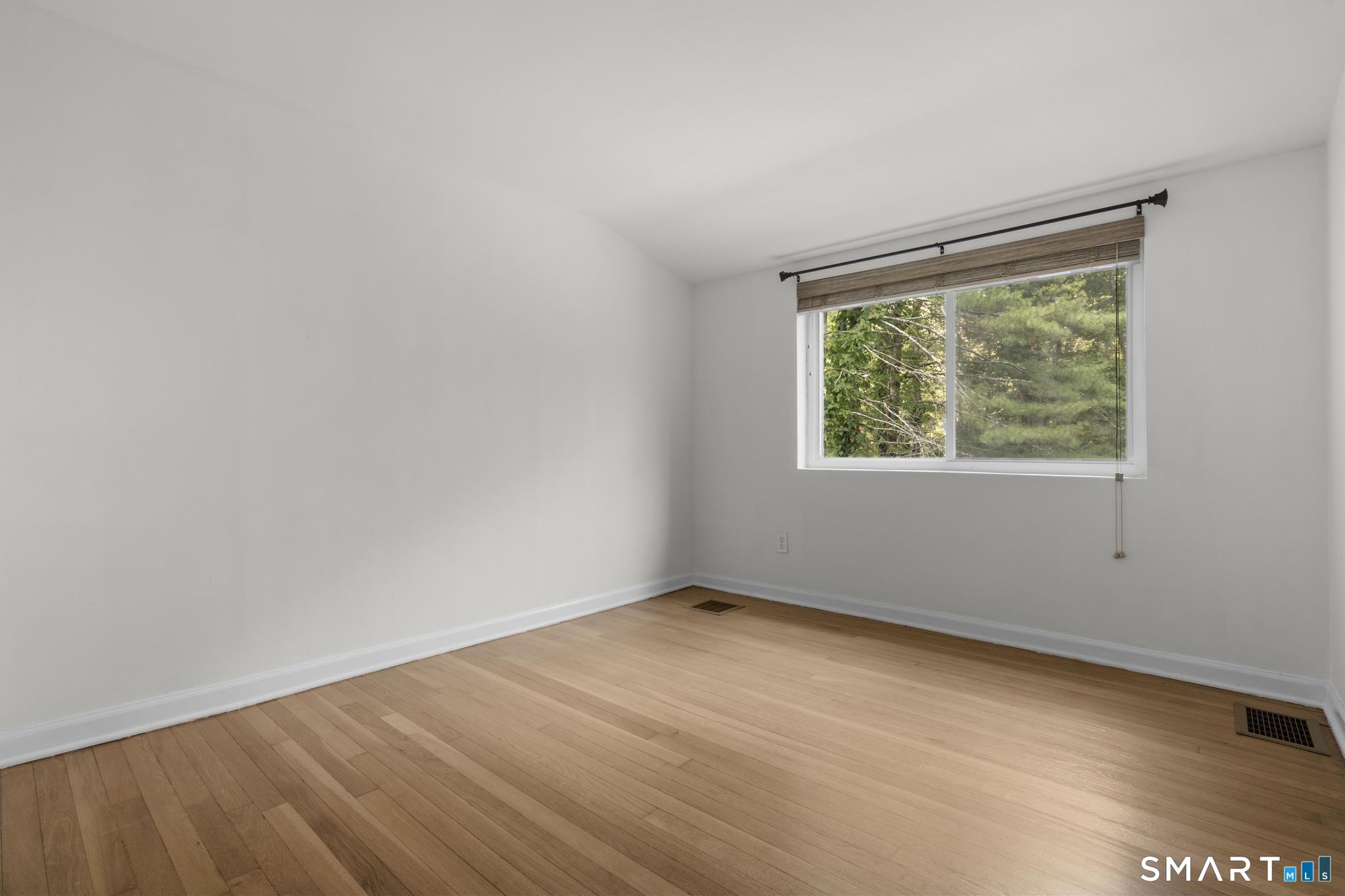 89 Book Hill Road Essex, CT 06426 - Photo 26 of 40 an empty room with wooden floor and windows