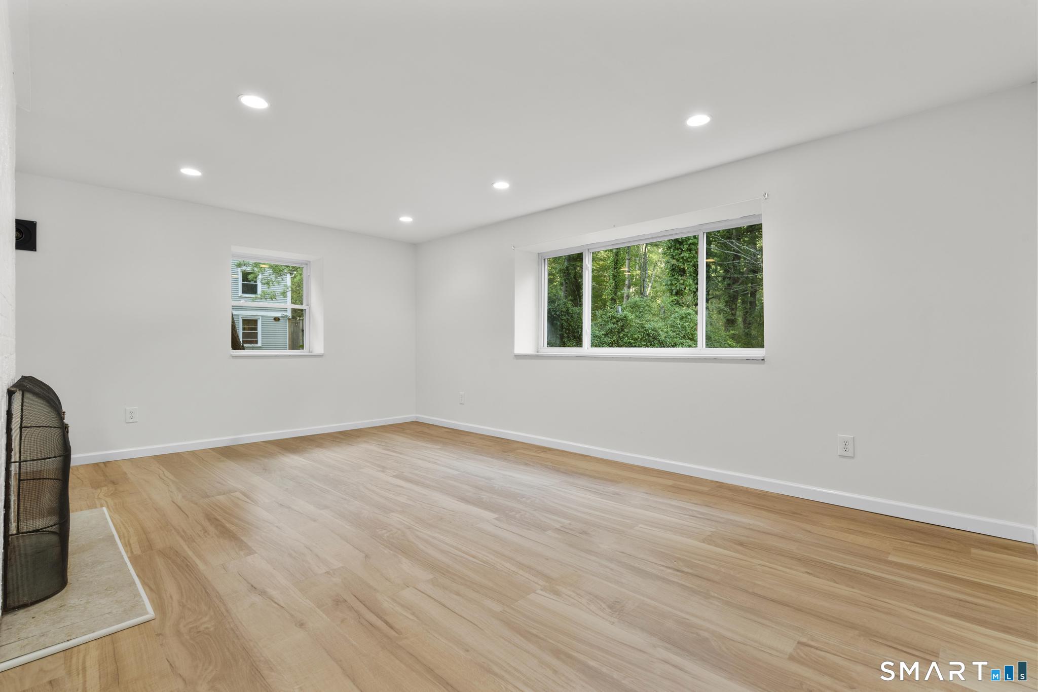89 Book Hill Road Essex, CT 06426 - Photo 30 of 40 an empty room with wooden floor and windows