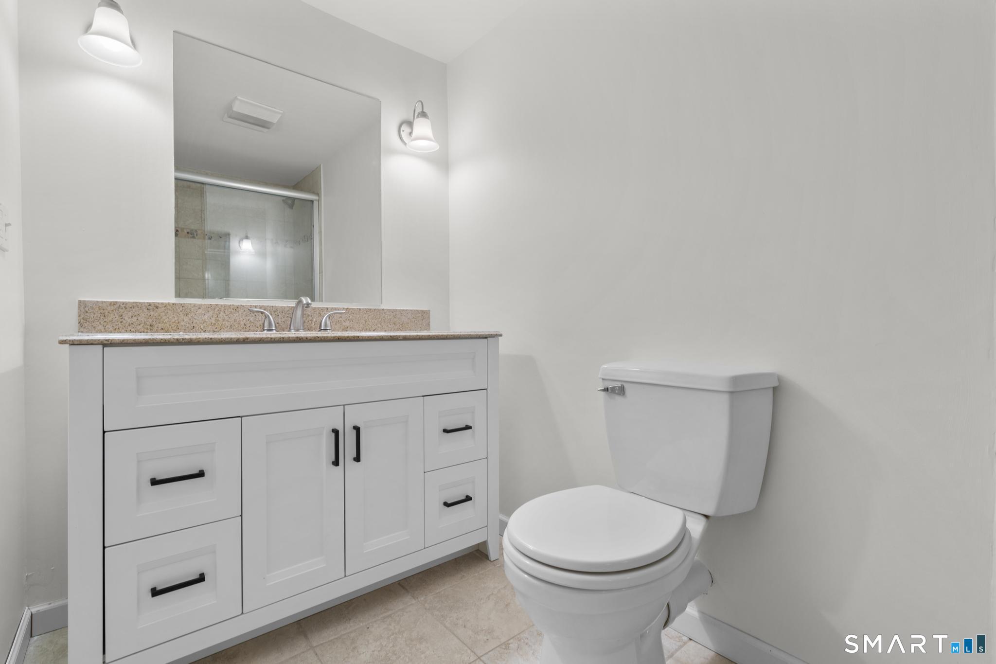 89 Book Hill Road Essex, CT 06426 - Photo 32 of 40 a bathroom with a granite countertop toilet sink and mirror
