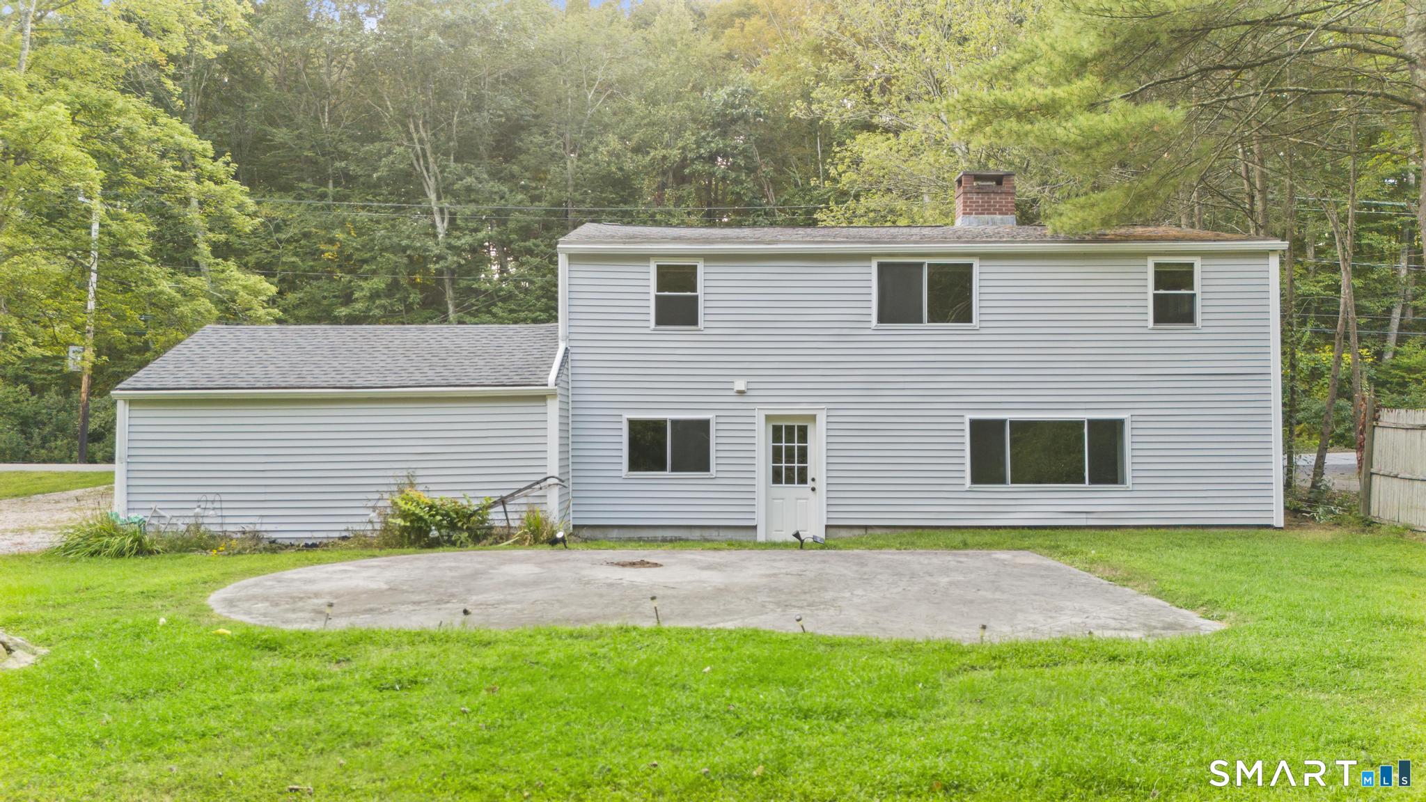 89 Book Hill Road Essex, CT 06426 - Photo 4 of 40 a front view of a house with a yard and garage