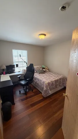 a view of a yard with a table and chair under an umbrella