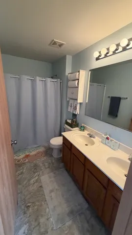 a view of a bathroom with a sink mirror and toilet