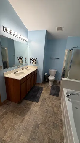 a bedroom with a bed and a couch