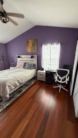 a spacious bedroom with a bed and a couch
