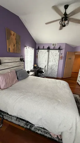 a spacious bathroom with a double vanity sink a large mirror and toilet