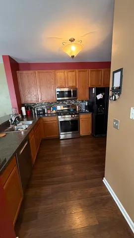 a kitchen with a large counter top space appliances and cabinets