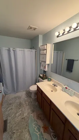 a view of hall way with furniture and chandelier