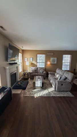 a living room with furniture a window and a fireplace