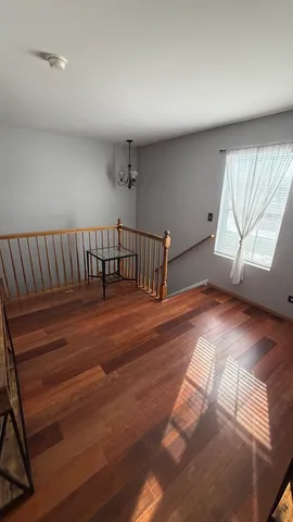 a bedroom with a bed and a flat tv screen on dresser