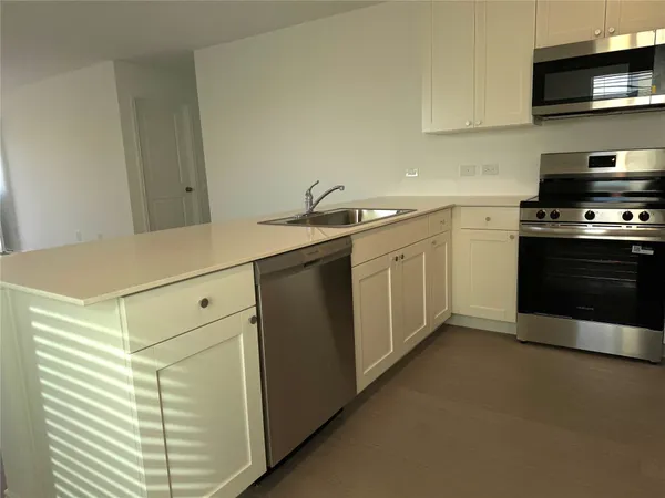 a kitchen with a sink and a stove top oven