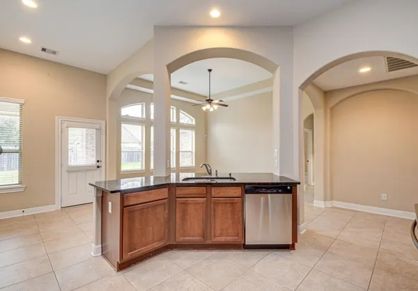 a view of a kitchen with a sink and chandelier