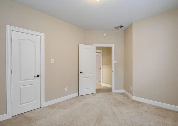 a view of an empty room and closet area