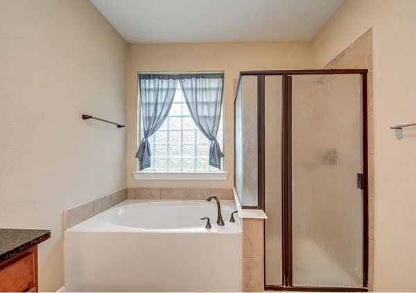 a bathroom with a bathtub and a shower