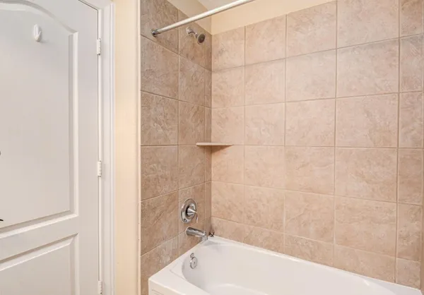 a bathroom with a bathtub and shower