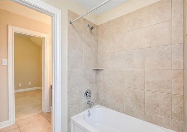 a bathroom with a tub and shower