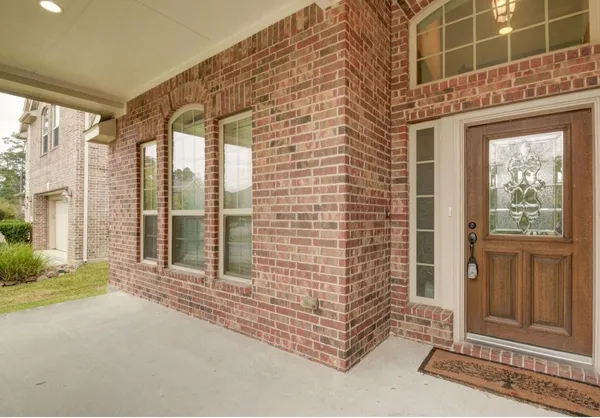 a view of a brick house with a large windows