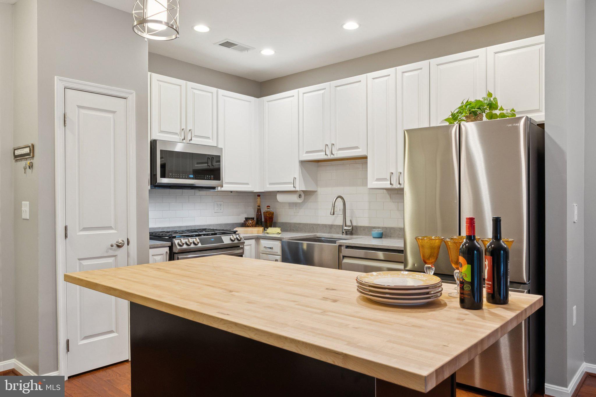 a kitchen with stainless steel appliances a stove a sink and a refrigerator