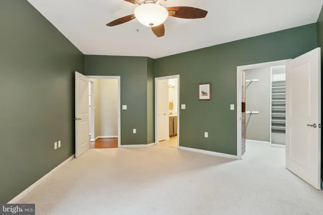 a view of a livingroom with a chandelier fan and a kitchen