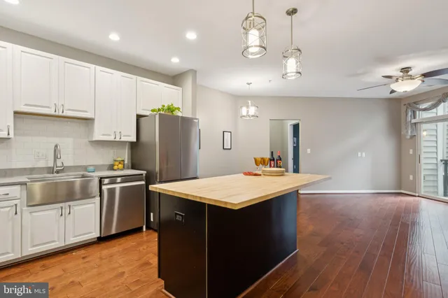 a kitchen with kitchen island a sink appliances and cabinets