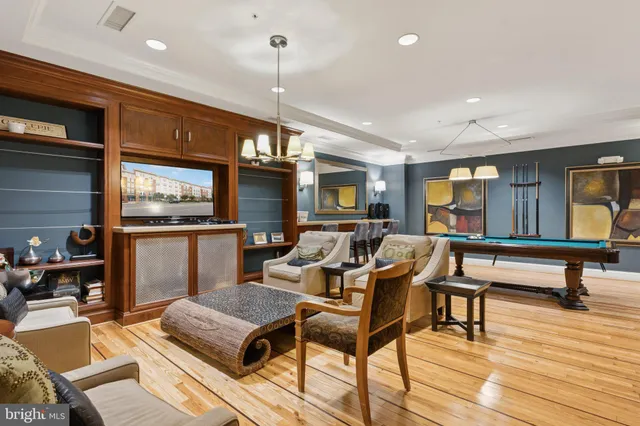 a living room with furniture a rug and a chandelier