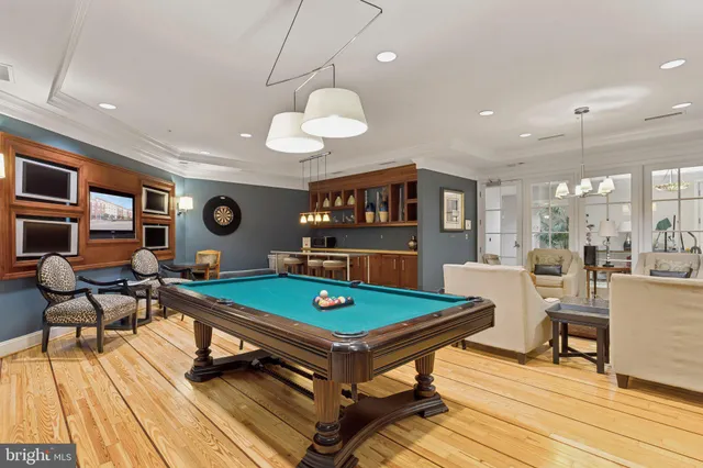 a living room with dining room and wooden floor