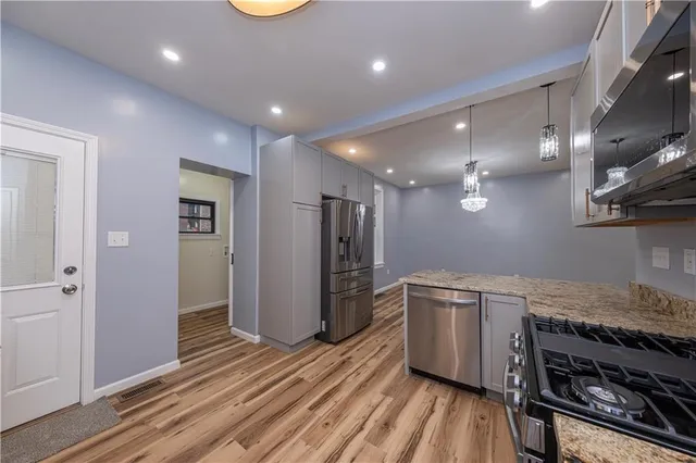 a kitchen with a stove and a refrigerator