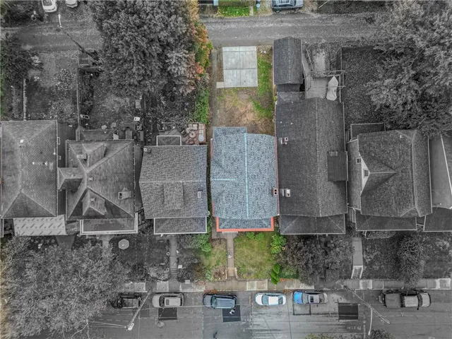 an aerial view of a house with a yard