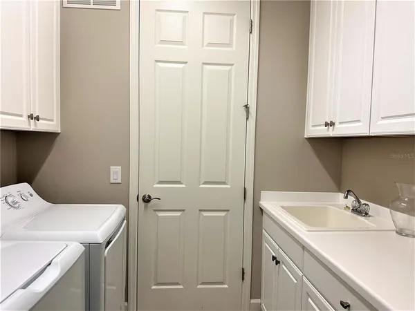 a bathroom with a sink and cabinets