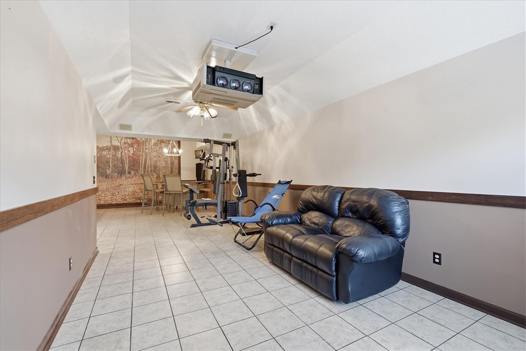 1052 Madden Bridge Road Central, SC 29630 - Photo 30 of 50 Tiled flooring and vaulted ceilings create a highly adaptable basement recreation space.