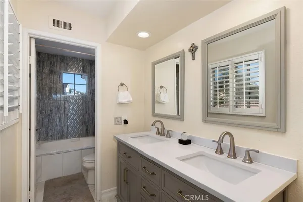 a bathroom with a tub shower and a sink