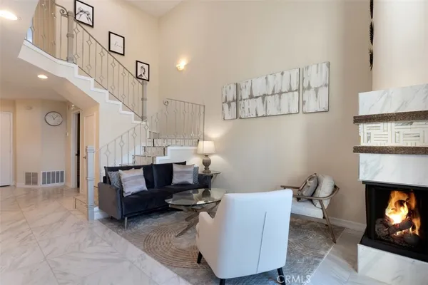 a living room with furniture and a fireplace