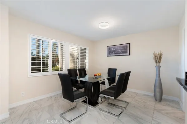 a view of a dining room with furniture and windows