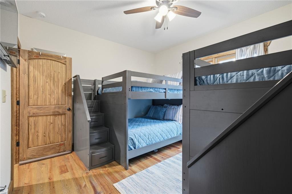 41 Bunks Way Morganton, GA 30560 - Photo 20 of 33 a bedroom with a bed and a chandelier