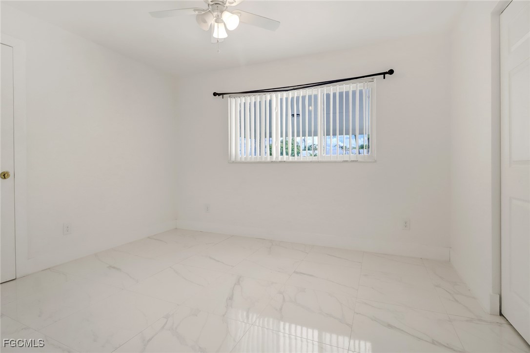 4838 Tudor Drive Cape Coral, FL 33904 - Photo 13 of 20 an empty room with windows