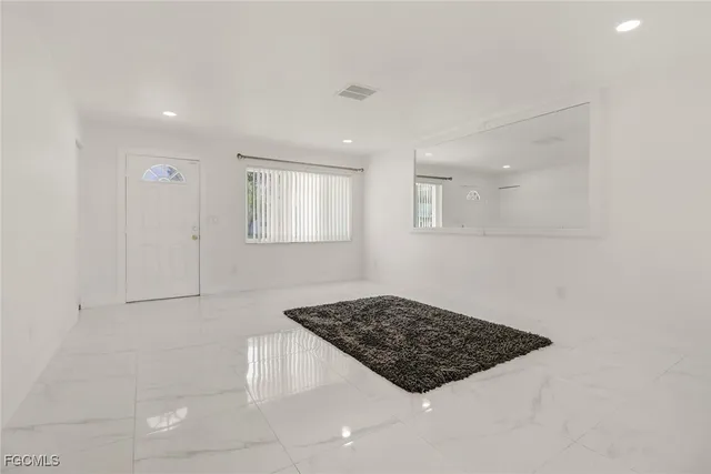 a view of a utility room with window and wooden floor