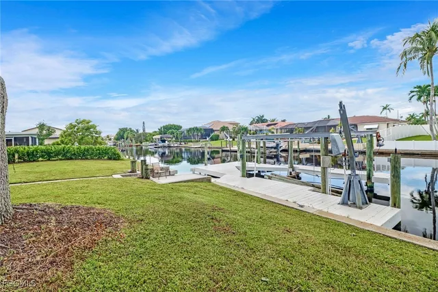 a view of yard with swimming pool and green space