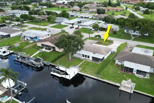 an aerial view of a swimming pool with lawn chairs and plants