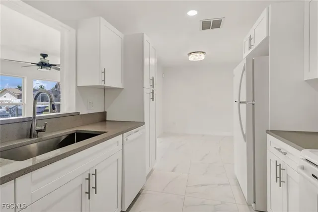 a kitchen with a sink and cabinets