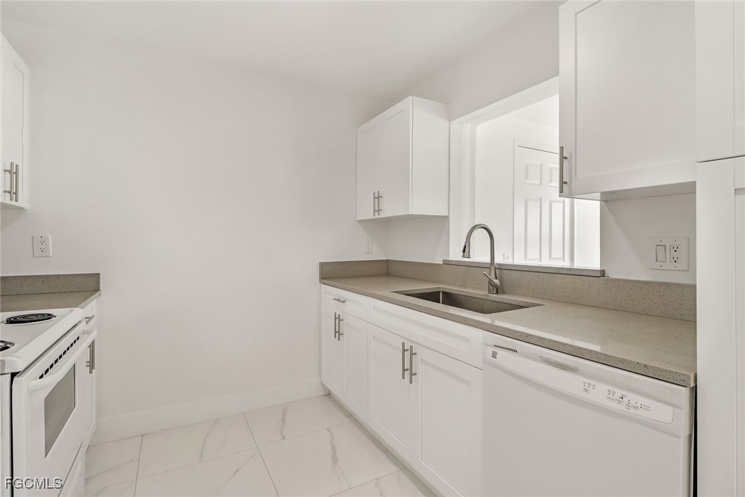 4838 Tudor Drive Cape Coral, FL 33904 - Photo 5 of 20 a kitchen with a sink and cabinets