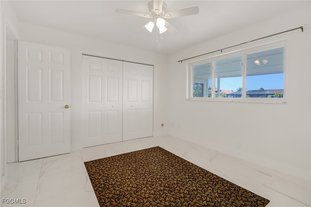 4838 Tudor Drive Cape Coral, FL 33904 - Photo 10 of 20 a view of empty room with wooden floor