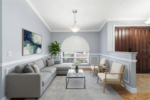 a living room with furniture a rug and a window