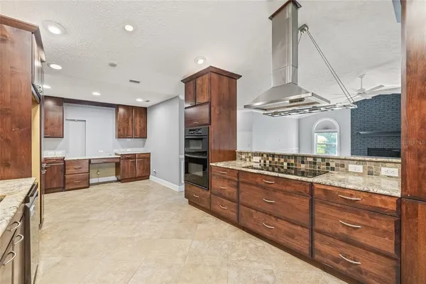 a kitchen with stainless steel appliances granite countertop a stove and a sink