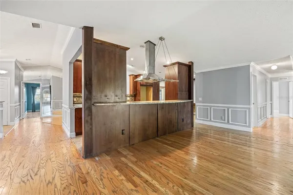 a view of a kitchen with wooden floor and a kitchen
