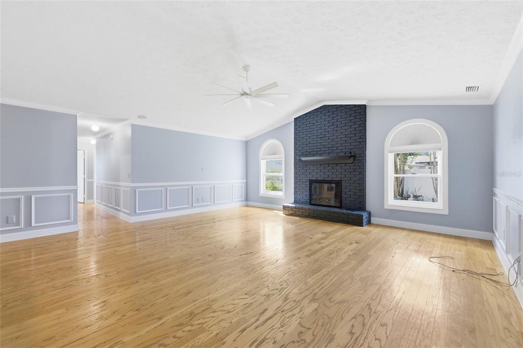 603 Cottage Grove Circle Valrico, FL 33594 - Photo 22 of 60 a view of empty room with wooden floor and fireplace