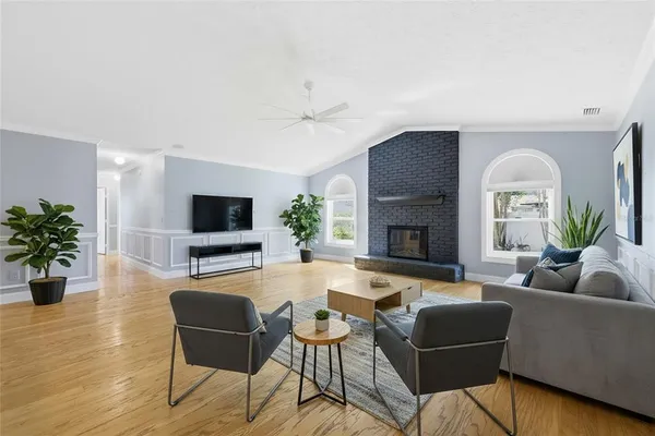 a living room with furniture a fireplace and a flat screen tv