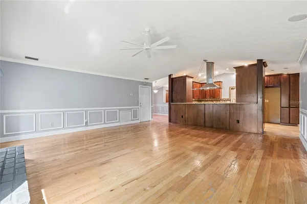a view of a kitchen with wooden floor and a kitchen