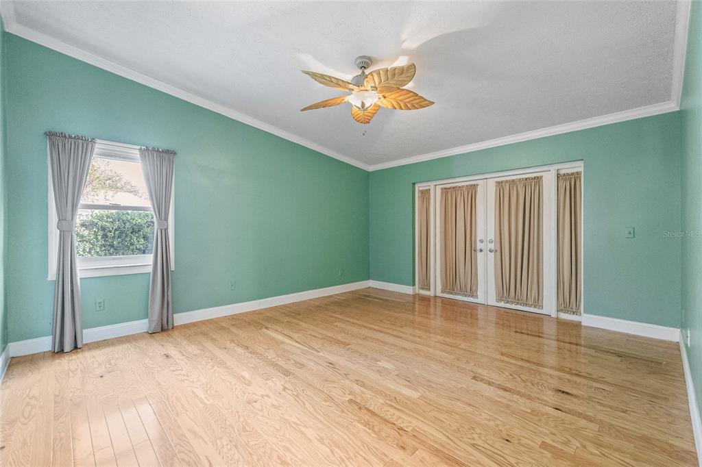 603 Cottage Grove Circle Valrico, FL 33594 - Photo 28 of 60 a view of an empty room with wooden floor and a window