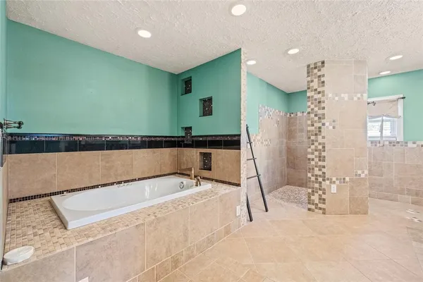 a bathroom with a bathtub and a shower
