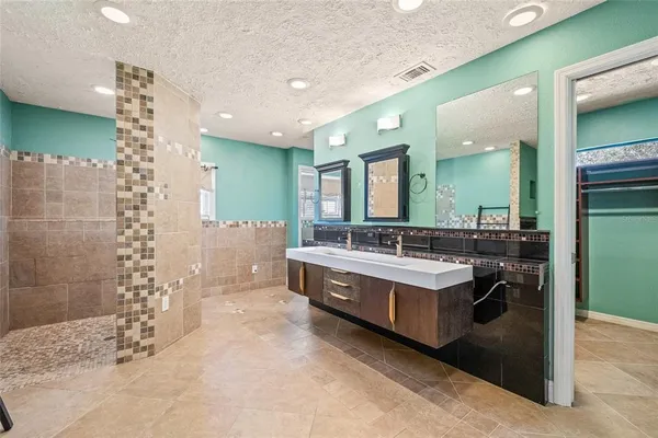 a spacious bathroom with a bathtub sink and mirror
